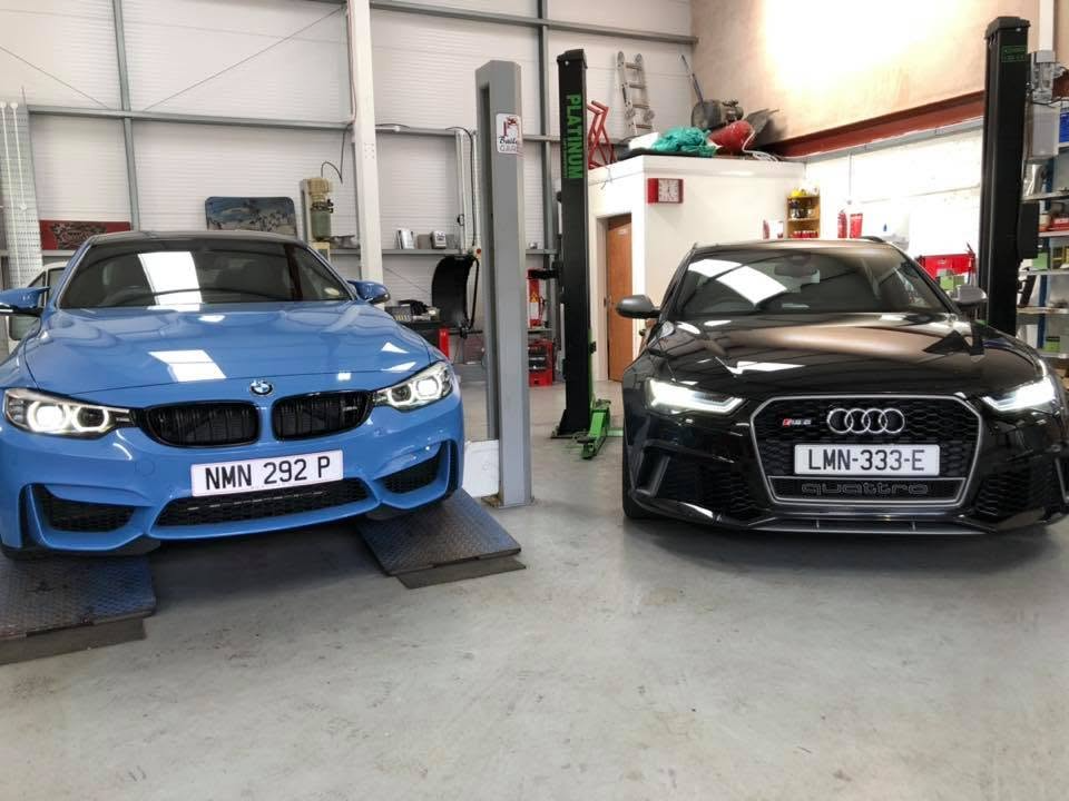 A BMW M car and an Audi RS6 up on the ramps at Bailey's Garage